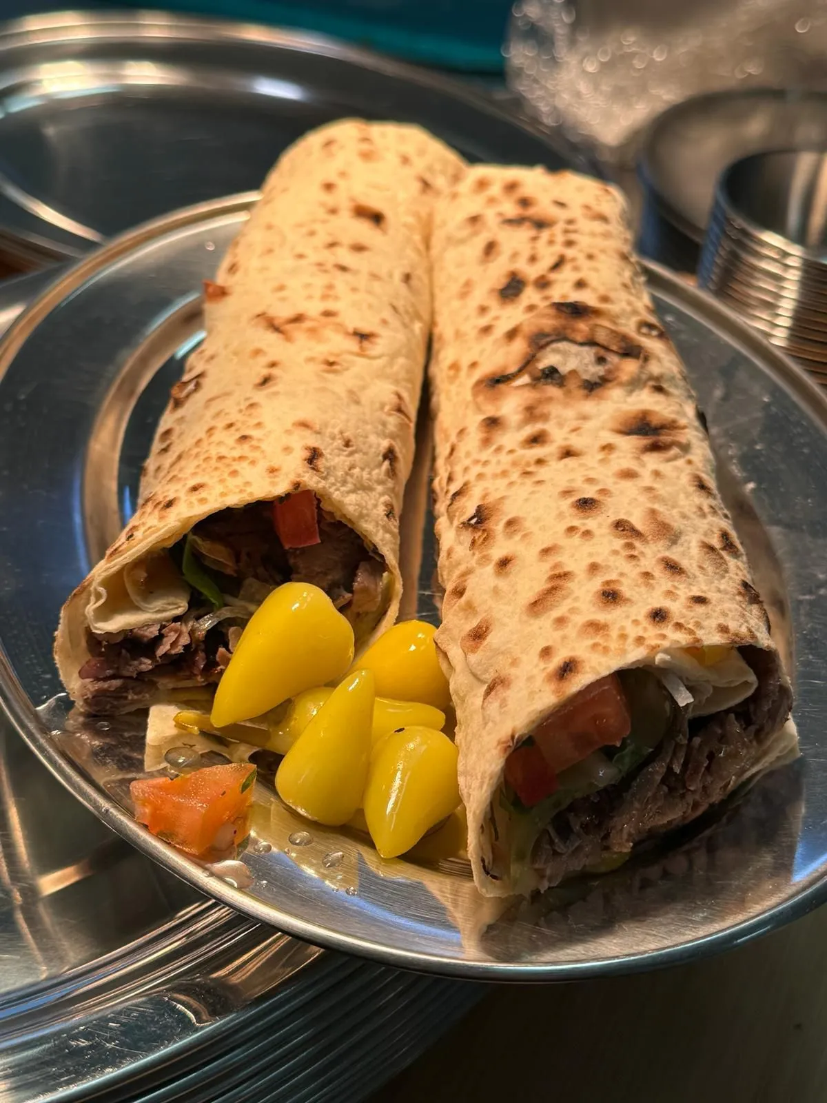 Turkish doner wrap dürüm served with fresh vegetables and pickled peppers at Elite Turkish Cuisine in London Ontario